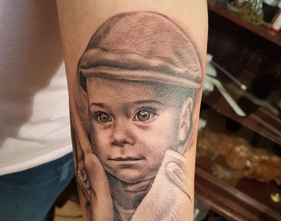 Child portrait tattoo on forearm – black and grey realism, Evgenij Korsun, Tattoo Jaga Wiesbaden