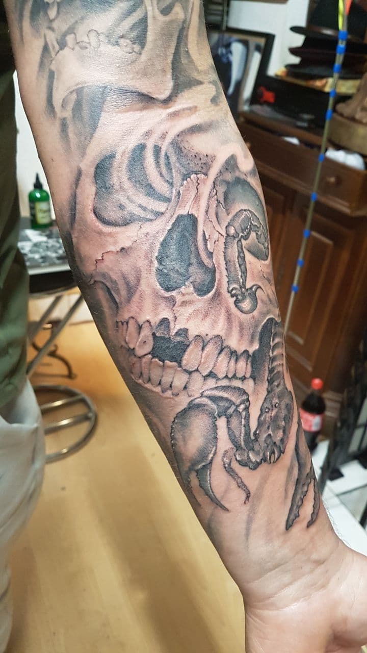 Black and grey realism tattoo on forearm – skull with scorpion, by Evgenij Korsun, Tattoo Jaga Wiesbaden